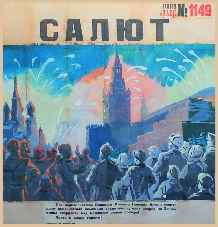 Crowd of people watch fireworks display; blue, pink, black